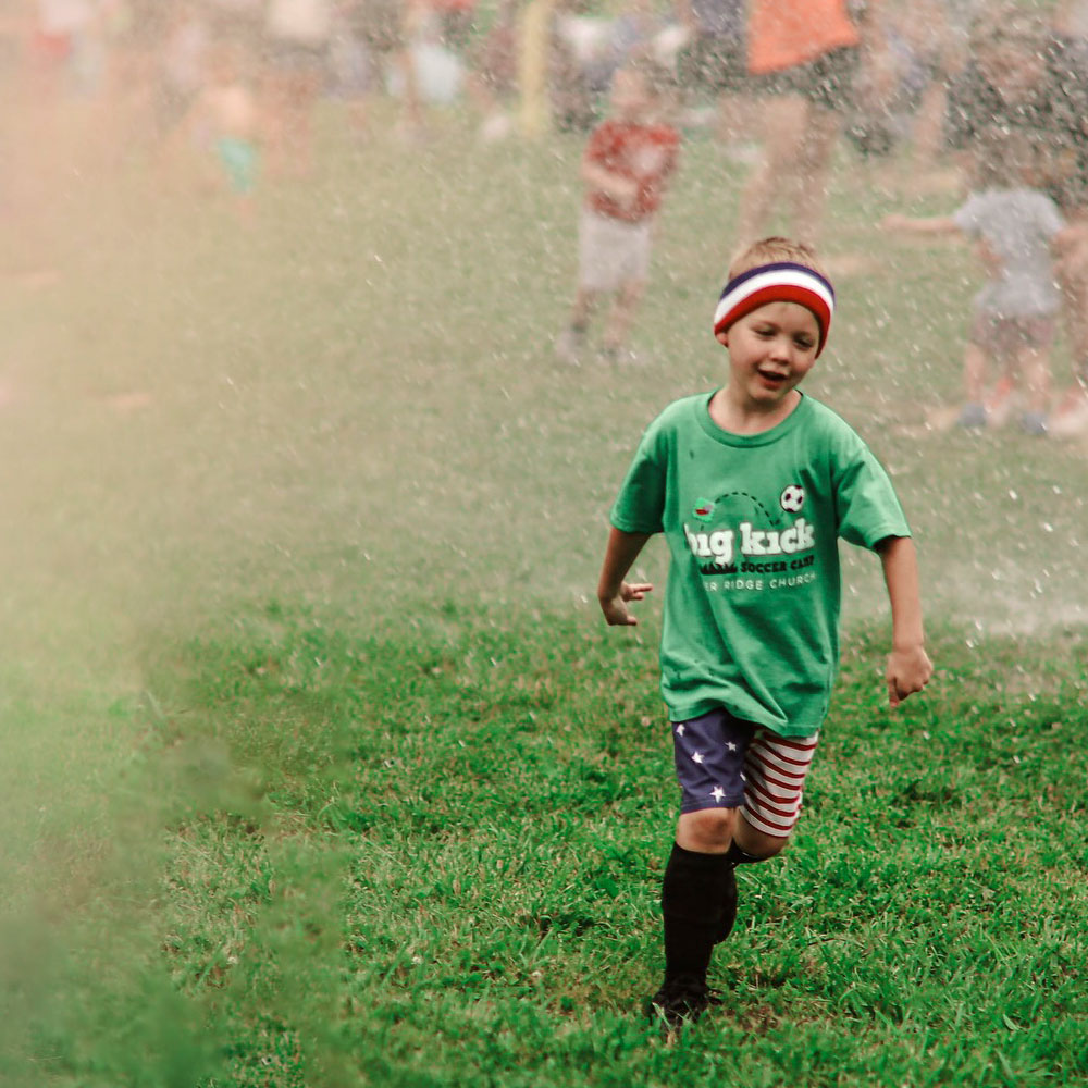 little kid playing soccer